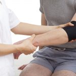 physiotherapist fixing elbow